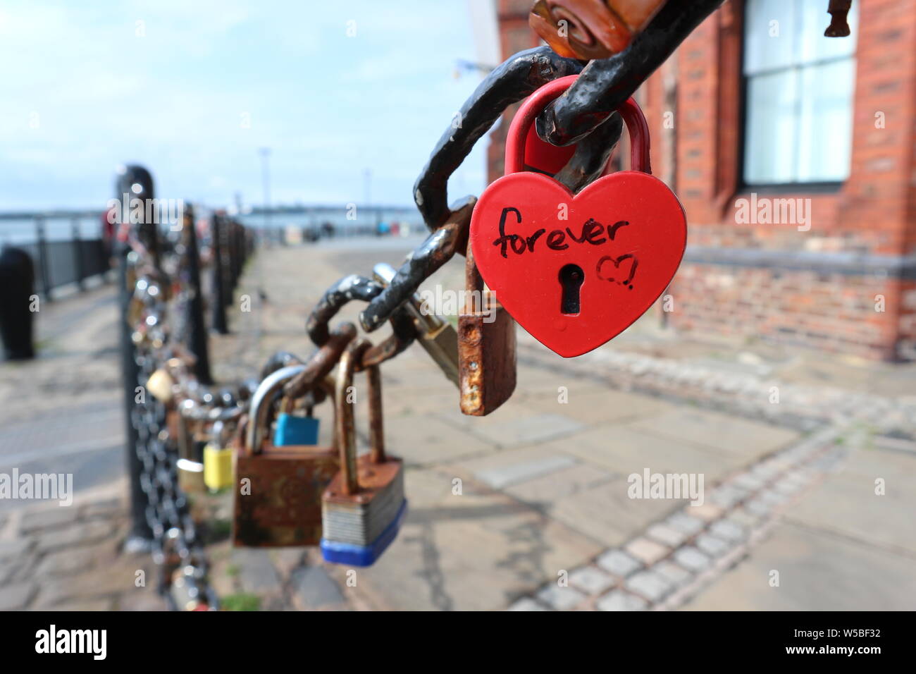 Iron chain fence with hanging padlocks at Liverpool`s Royal Albert